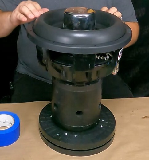 Sundown Audio dust cap weight used during subwoofer recone process to ensure proper bonding and alignment while glue cures for accurate speaker repair.