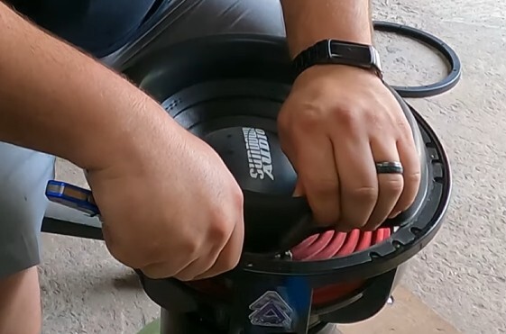 Sundown Audio subwoofer recone process showing removal of old cone, surround, and spider during subwoofer repair to prepare for new recone components.