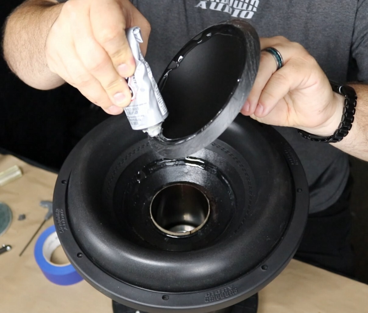 Sundown Audio E6000 dust cap glue used for subwoofer recone repair, ideal for bonding dust caps and surrounds with strong flexible adhesive for car audio subwoofers.